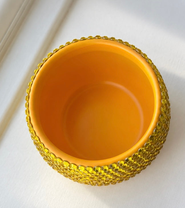 Close up shot showing mouth of yellow ceramic plant pot 
