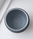 A top-down view of a Moon Dust gray with textured crystal accent set against a clean white background.