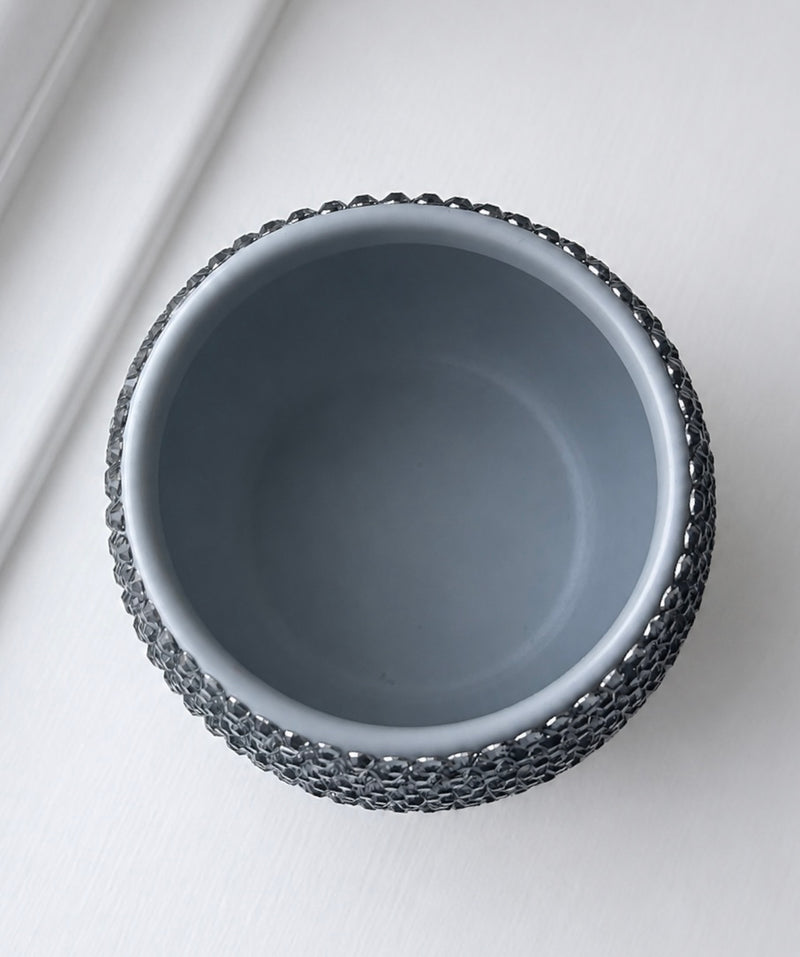 A top-down view of a Moon Dust gray with textured crystal accent set against a clean white background.